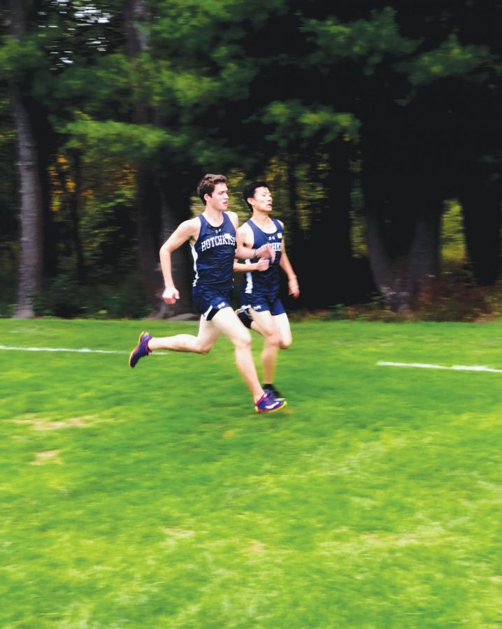 Ethan Sprole ’20 and Harry Li ’20 sprint to the finish line during a cross country meet.