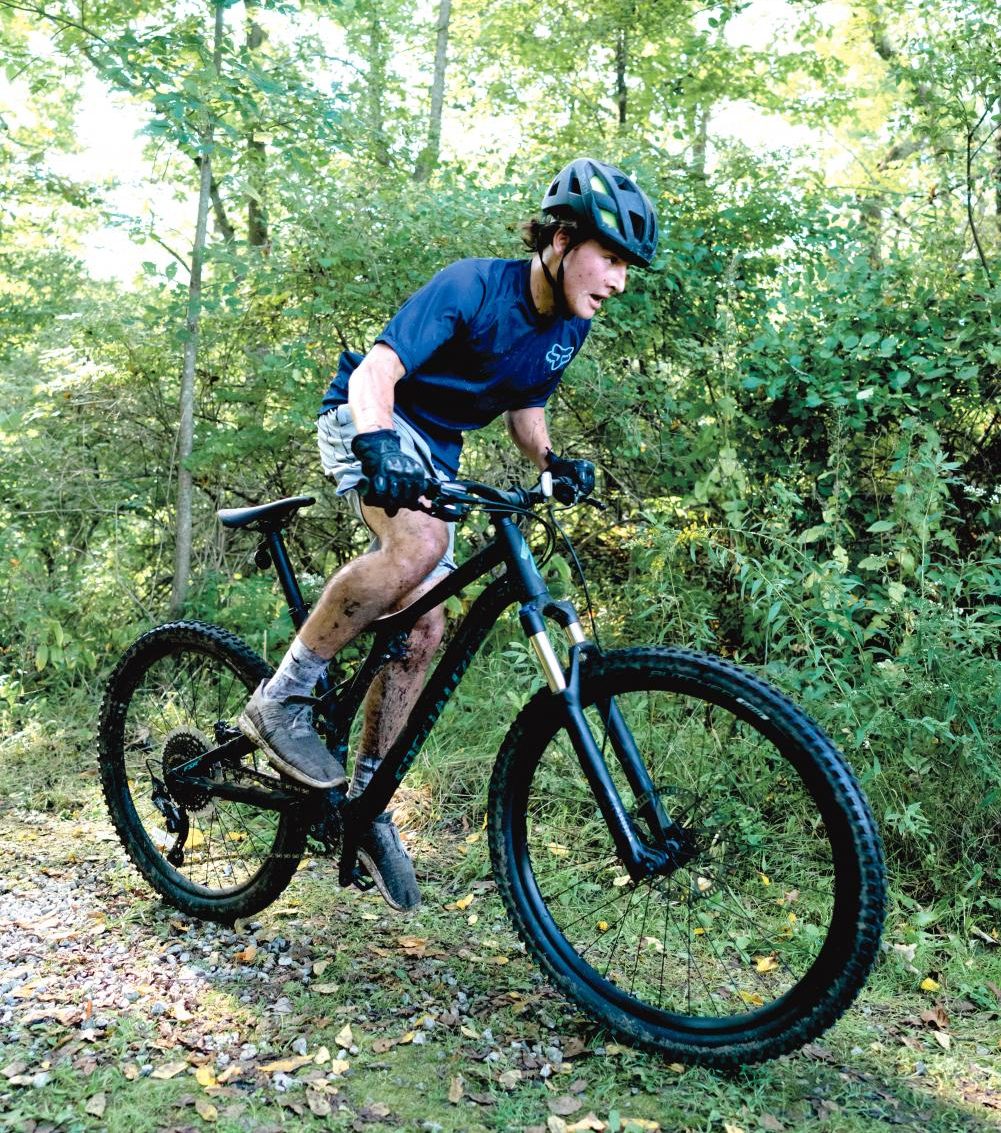 Alex Kulicki ’19 rides on a forest trail.