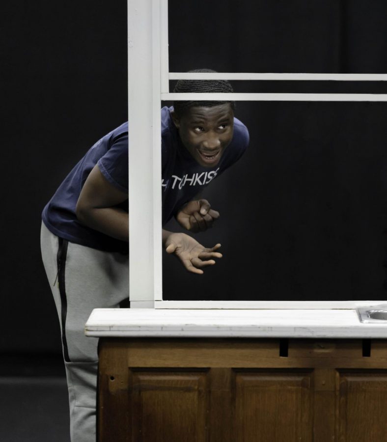 Souleman Toure ’19 gestures through a window during a Black Box rehearsal last year. 