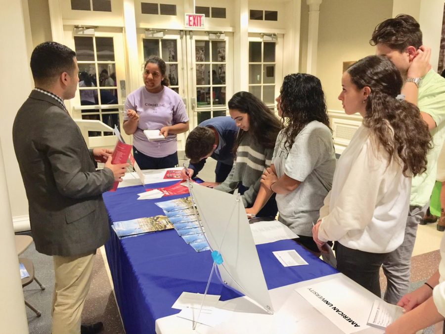 Hannah Lothian ’19 chats with Mr. Kevin Mondragon, American University’s representative, at the college fair last Wednesday.