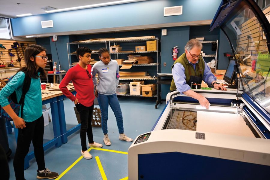 Mr. Brad Faus, director of visual arts, demonstrates the laser cutter in the EFX Lab. 