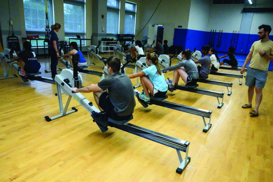 Members of the Fall Rowing co-curricular learn basics on Erg machines in the MAC.