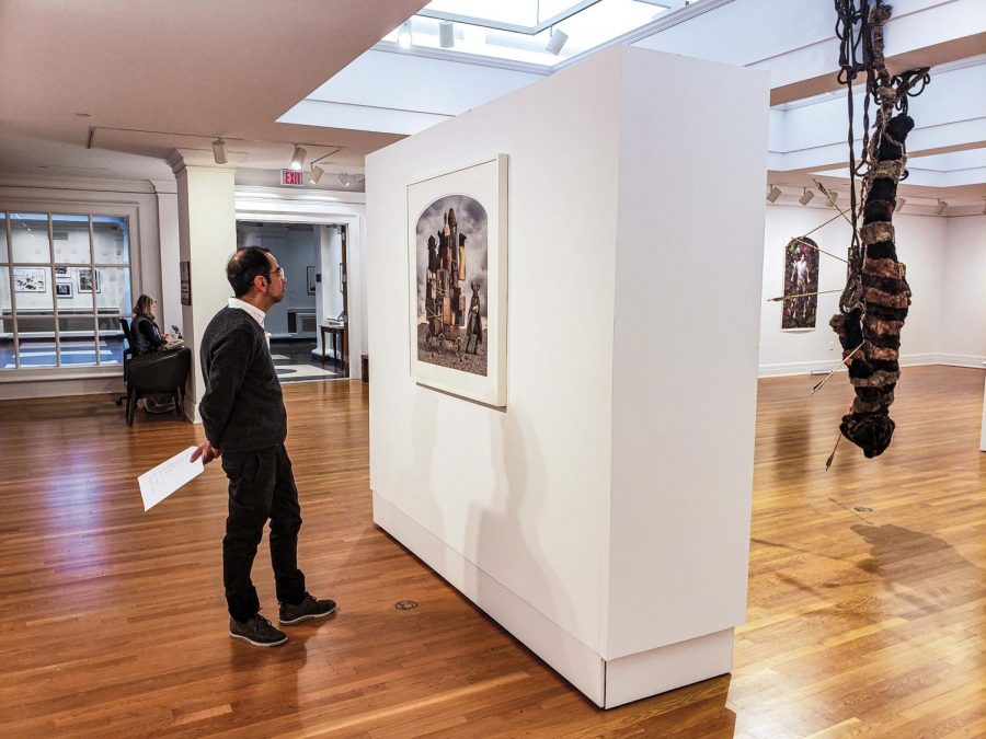 Francisco Barrios, Instructor in Spanish, takes in a scene from the gallerys newest exhibit.