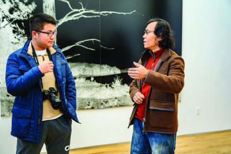 Jerry Sheng ’20 translates for Shi Guorui as he introduces his works.