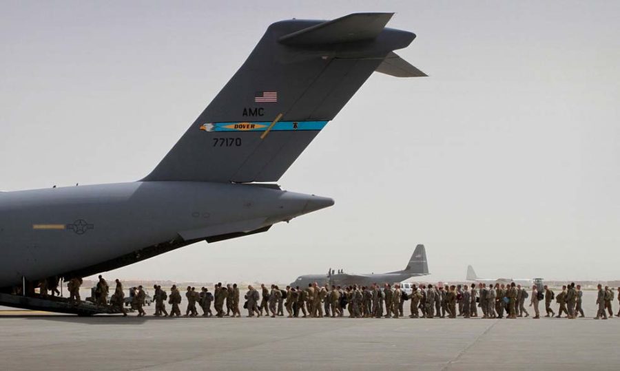 U.S. soldiers  board a U.S. military aircraft as they leave Afghanistan, at the U.S. base in Bagram, north of Kabul, Afghanistan, Thursday, July 14, 2011. The first groups of the U.S. soldiers left Afghanistan after President Barack Obama announced last month that he would pull 10,000 of the extra troops out in 2011 and the remaining 23,000 by the summer of 2012.