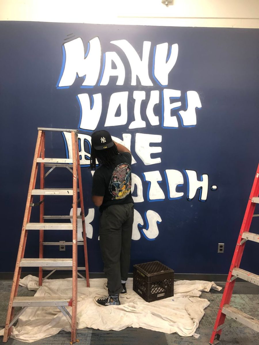 Pierre’s mural in the Multicultural Center reads “Many Voices One Hotchkiss.”