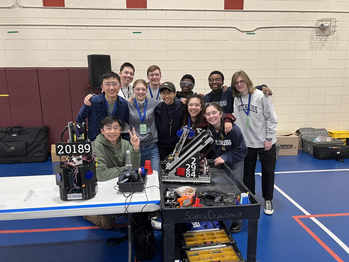 Members of the schools Robotics Team pose with their robots.