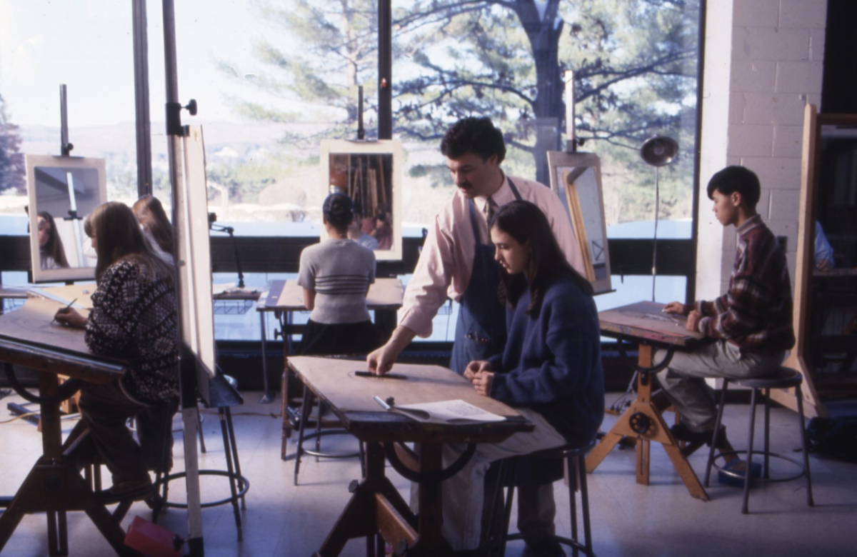 Mr. Faus instructs students in the art studio overlooking Lake Wononskopomuc.